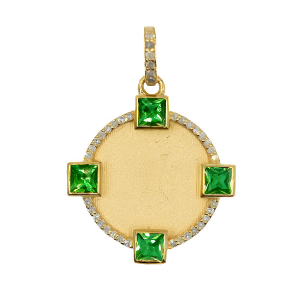 a gold pendant with green stones