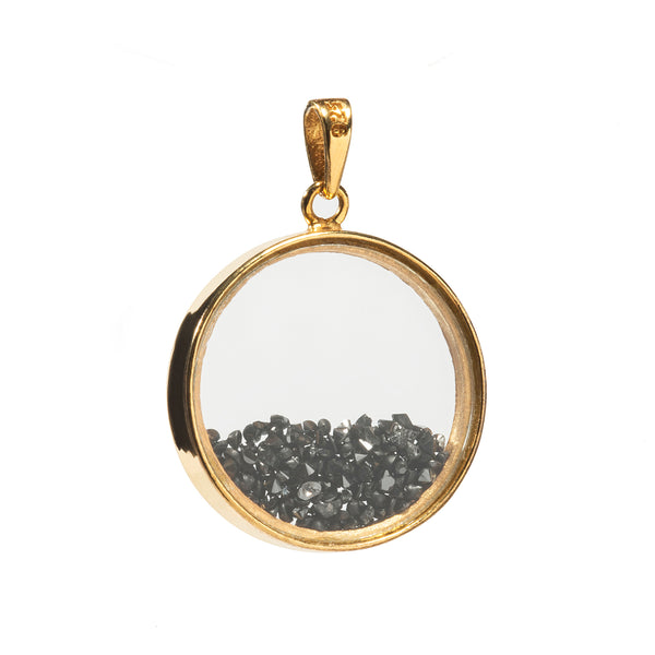a gold circle with black stones inside