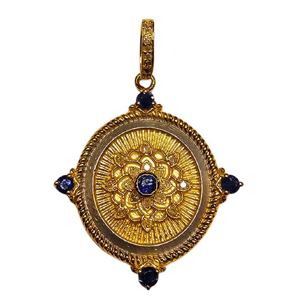 a gold medallion with blue stones