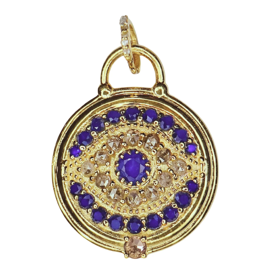 Gold evil eye blue sapphire pendant with on a white background
