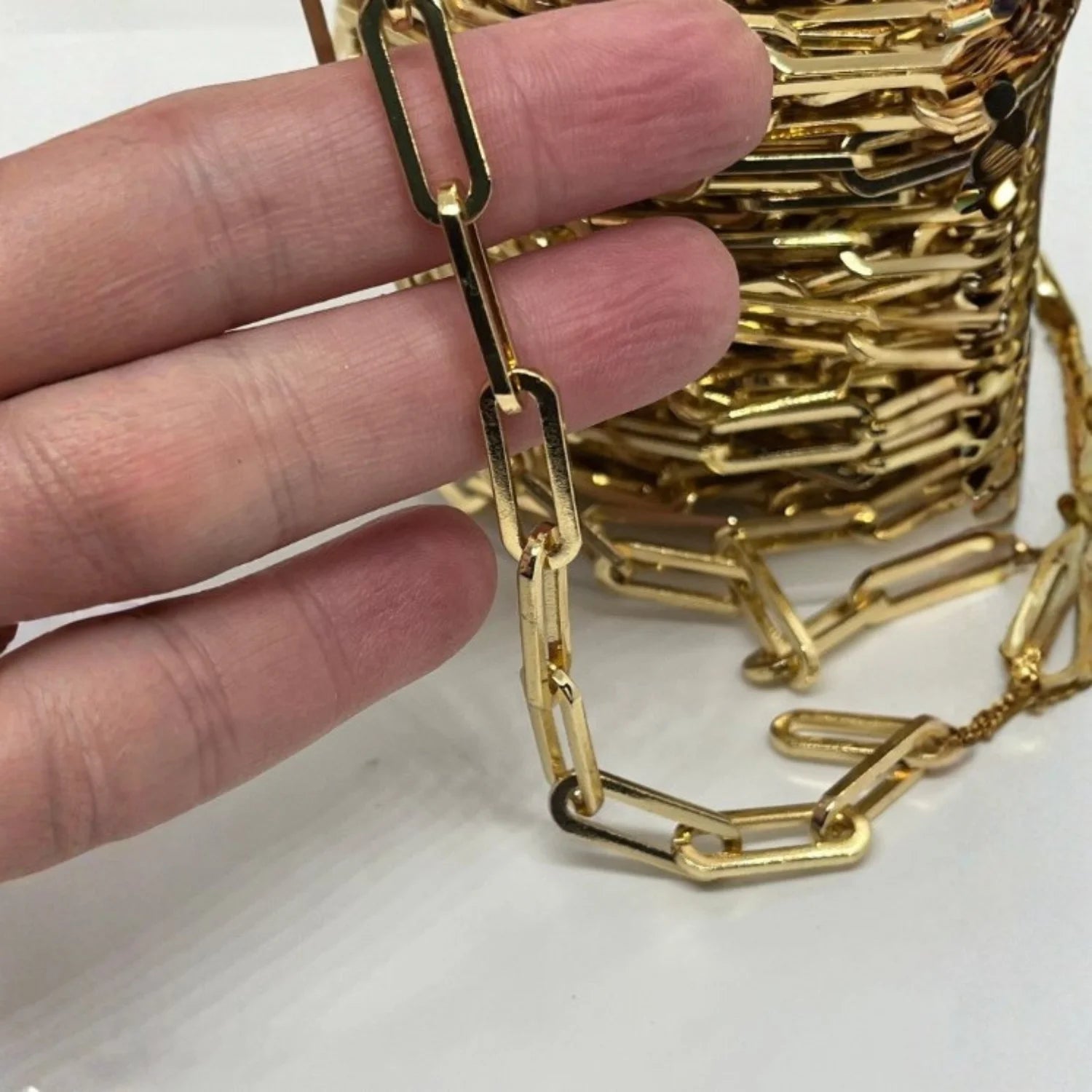 Chunky shiny gold paperclip necklace with gold Polki diamond closure, bold elegant luxury jewelry accessory