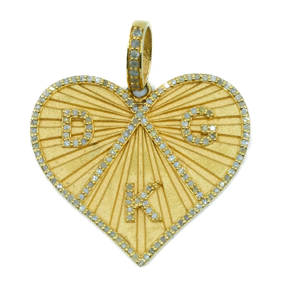 Gold heart-shaped pendant with engraved letters on a white background