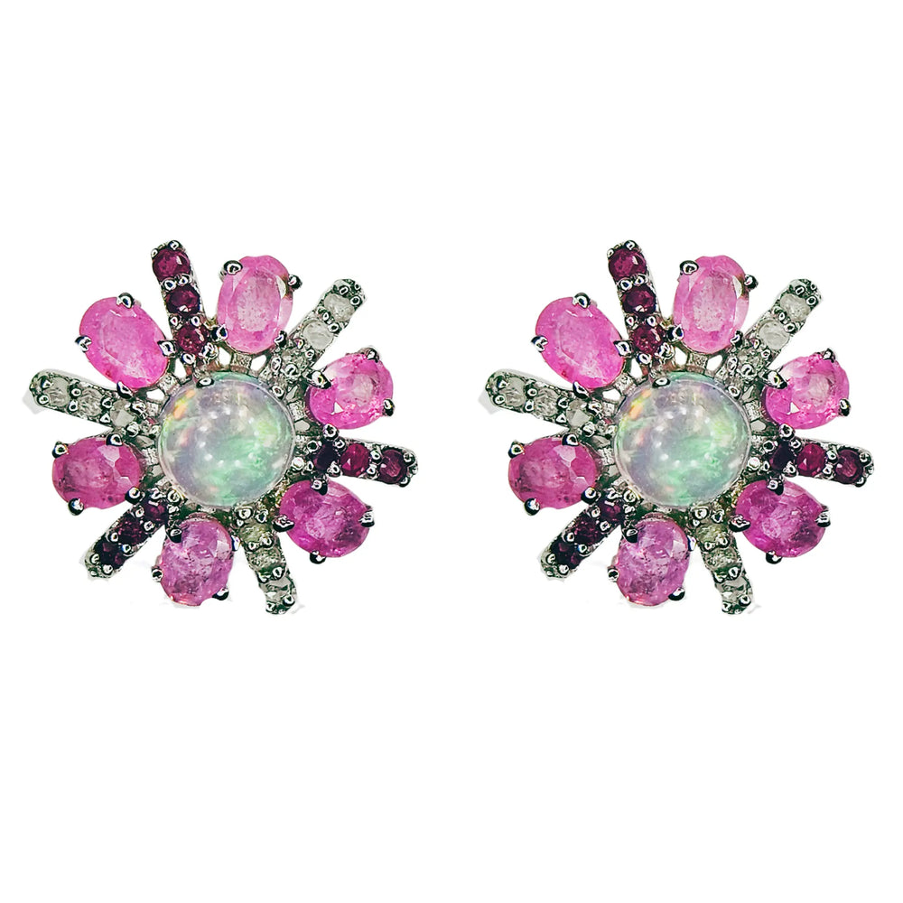 Pair of earrings with pink sapphire and diamond gemstones and a central opal stone on a white background